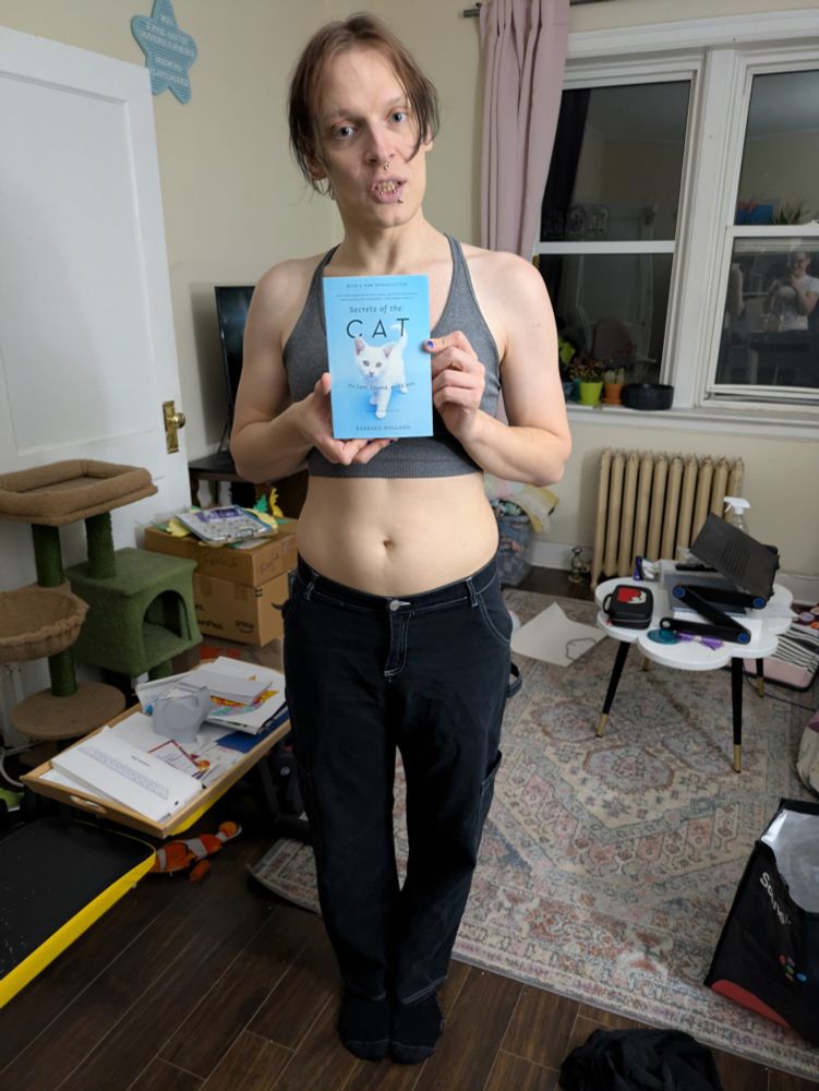 The read herring holding the book "secrets of the cat", picked up at the... Clothing swap. 