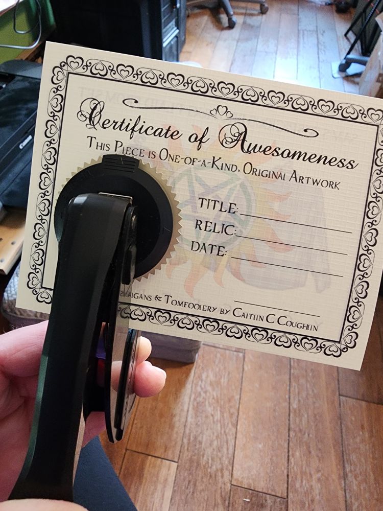 Certificate with hand squeezy embosser on it