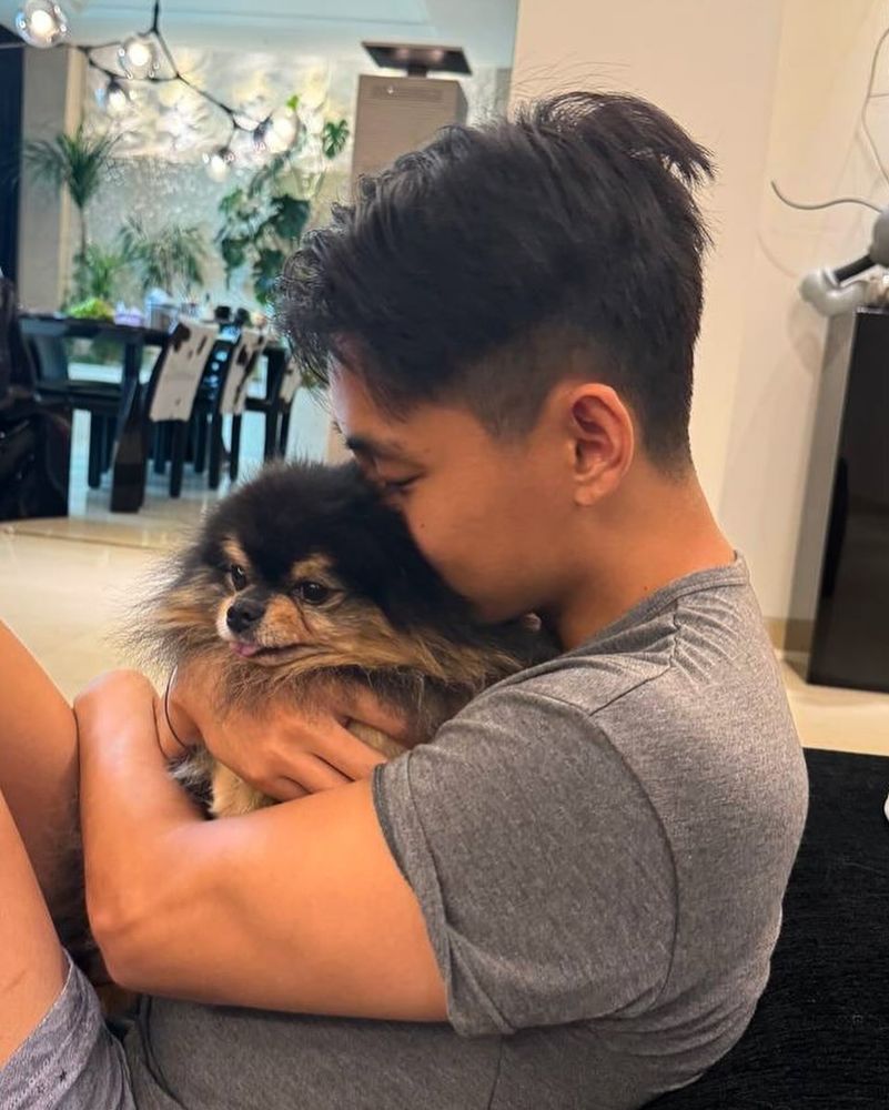 Taehyung hugging Yeontan tightly and burrying his face in his fur. Yeontan does a little blep. Tae's hair is short