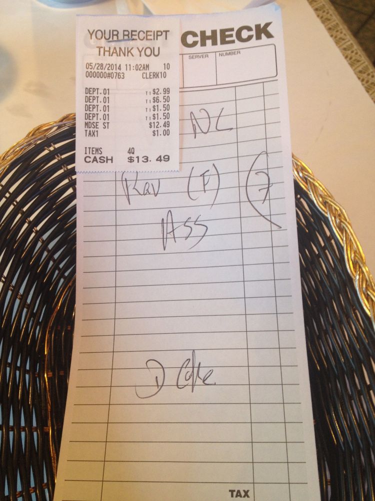 A handwritten receipt on which is written 'NC' (but the 'C' looks kind of like a capital 'L'), 'RAV (F)', 'HSS' (but the 'H' really looks like a capital 'A'), and 'D Coke'.