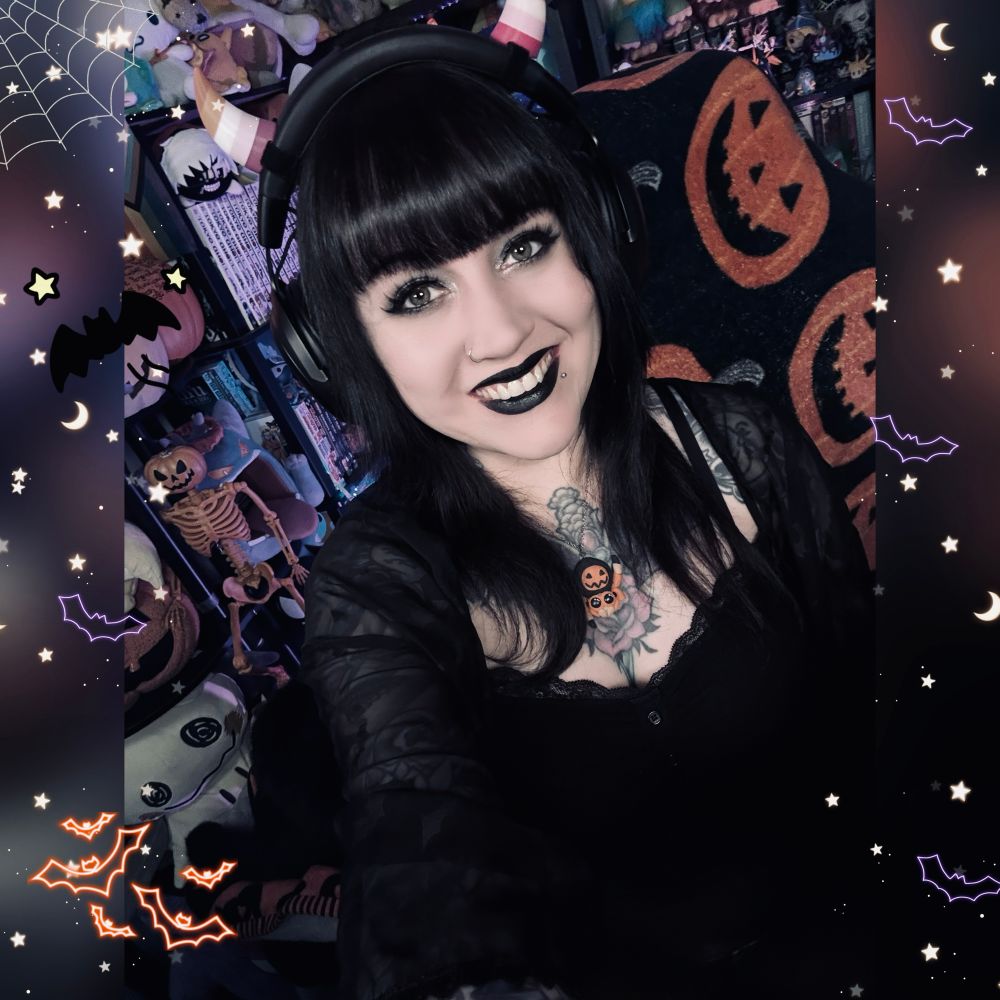 Me in my stream room in a black top and black lipstick 