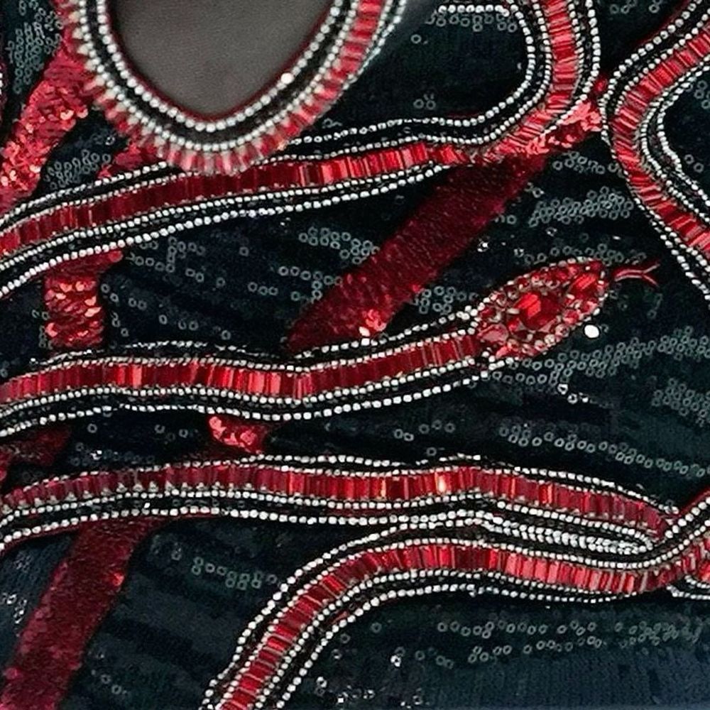 Close up of Taylor Swift’s black and red reputation outfit at the eras tour. 