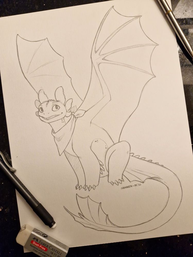 A friendly looking Night Fury sits and stares happily at the camera. He is wearing a bandana.