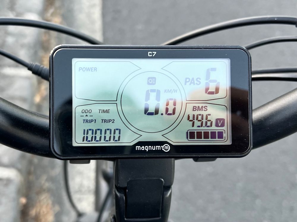 Photo of digital panel on e-bike showing odometer reading 10,000km