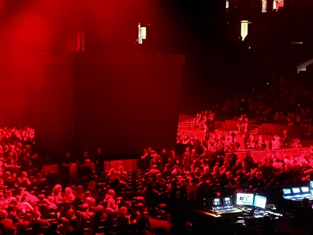 A picture of the Nine Inch Nails concert in the Oakland arena, showing a menacing-looking grey cube at the center of the red-lit stage.