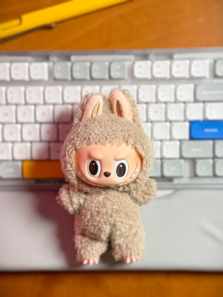 Toffee Labubu lays on a keyboard