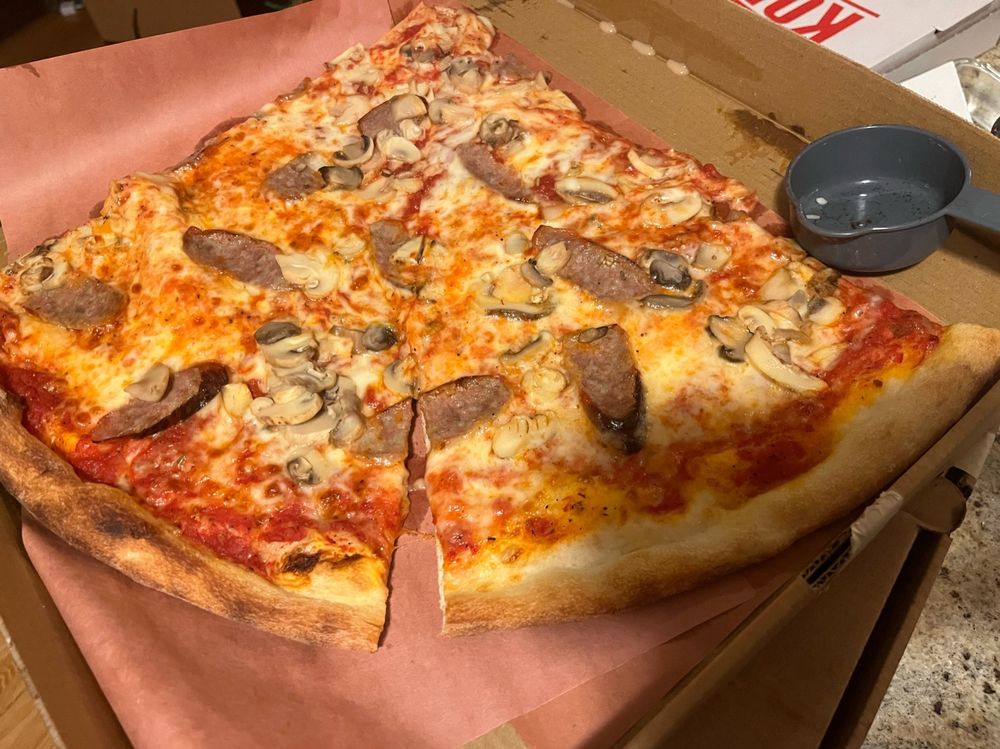 huge fuckin pizza slices wit mushroom and sausage