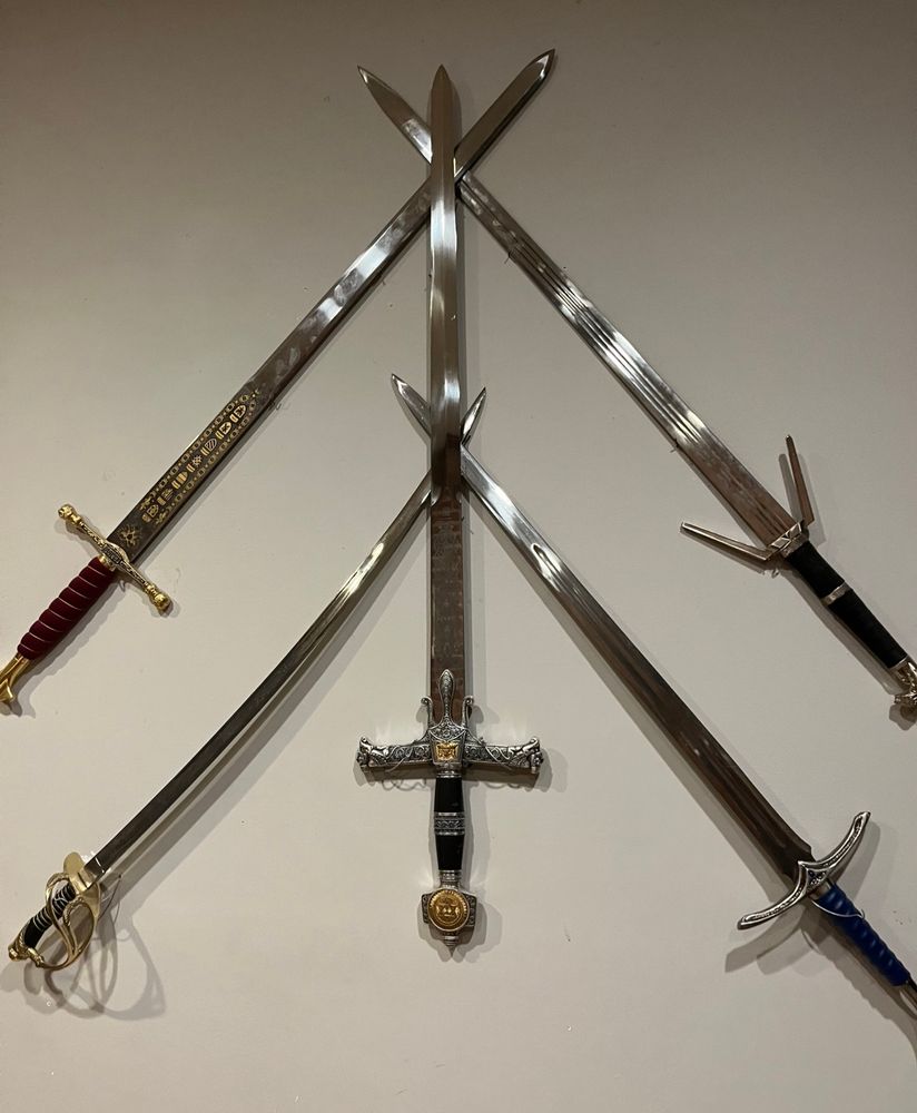 a decorative elaborate wall display of five swords