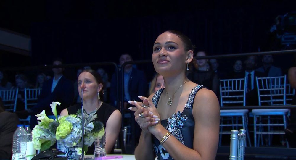 Andi looking like she’s crying, Trin looking so so proud