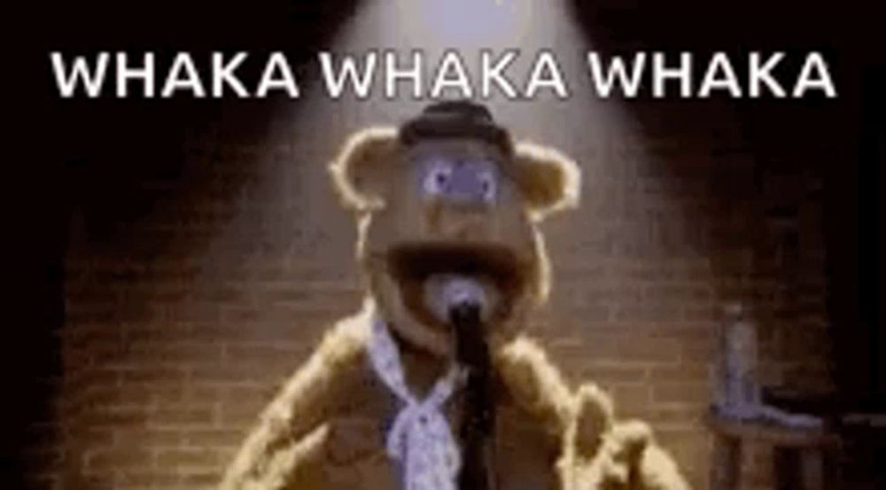 a teddy bear is singing into a microphone with the words `` whaka whaka whaka '' .