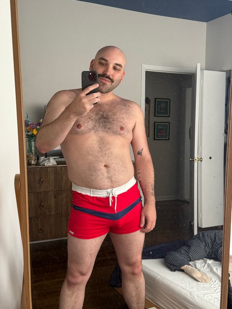 Mirror pic in red swim trunks