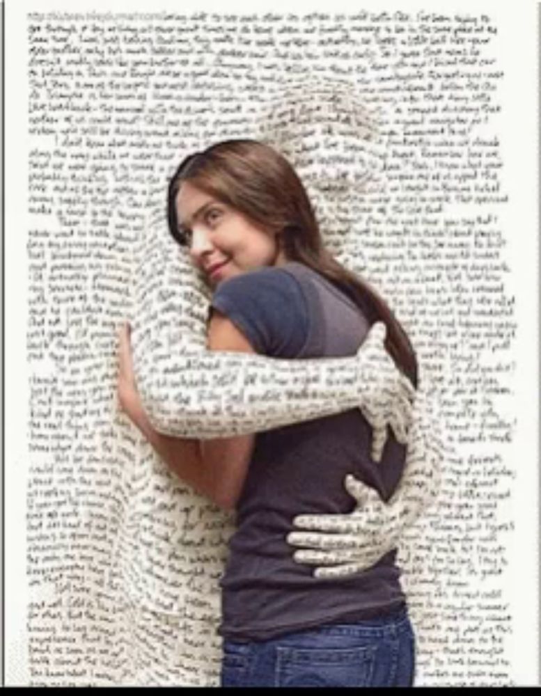 a woman is hugging another woman whose arms are covered in writing