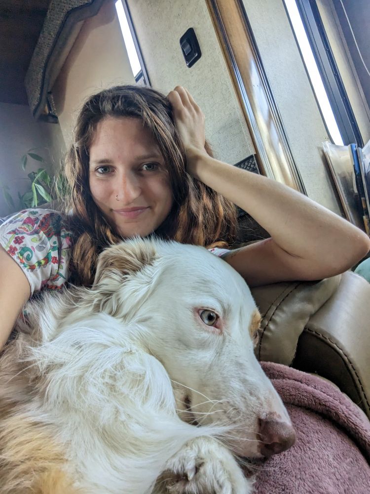 Camille with her dog on a couch