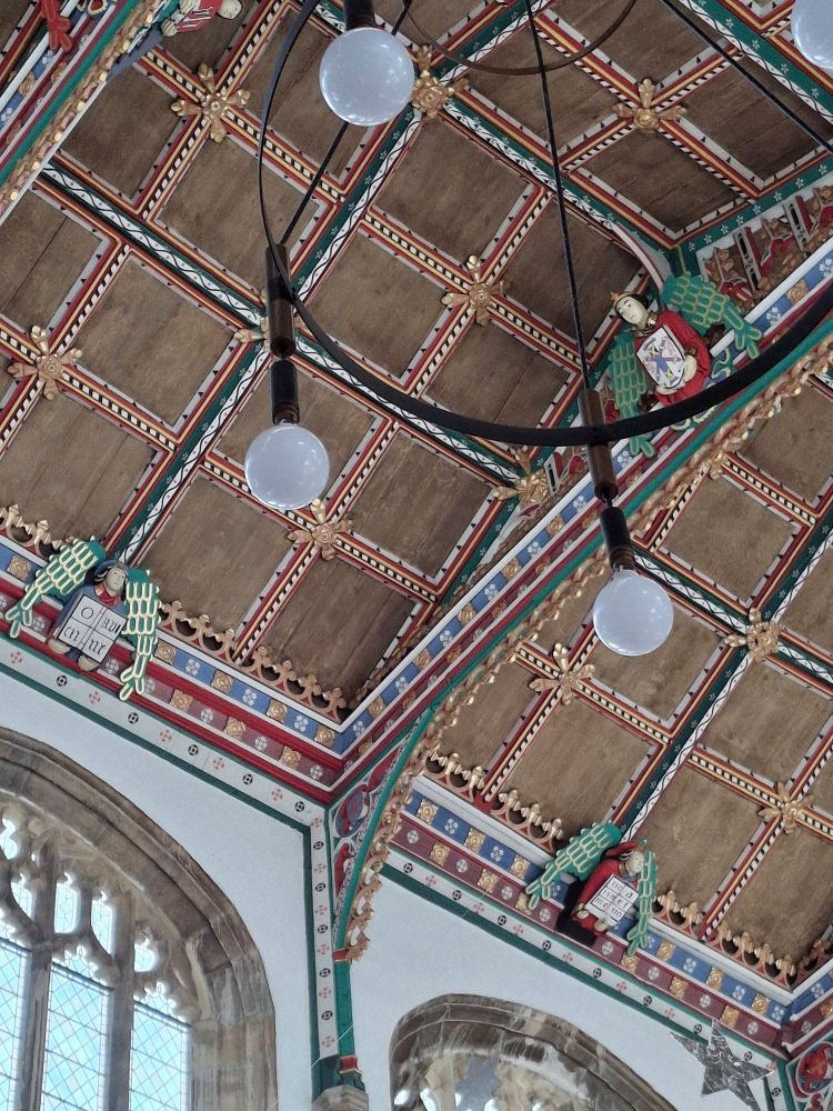 A colorful church roof with a square lattice pattern.