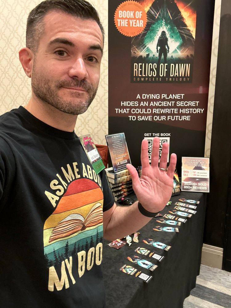 Author AW Davidson standing in front of his book display table at Capricon in Chicago