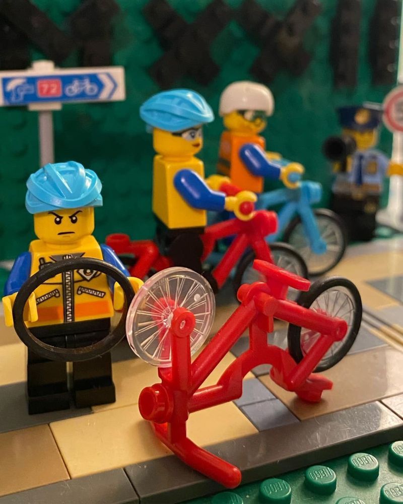 Lego figures changing a bicycle tyre as part of a model created by Steve Thomas