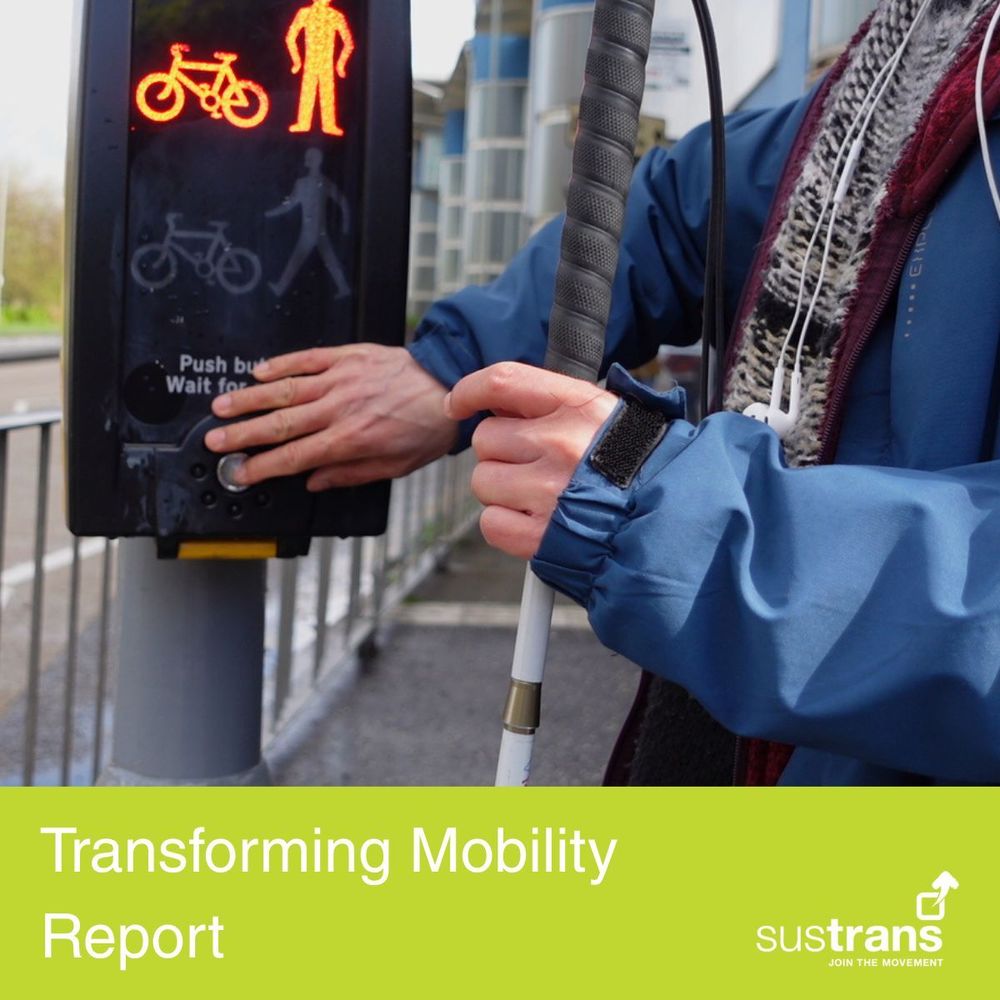 A photo of a person's hands pressing the button at a pedestrian crossing. They are holding a white cane. The text reads 'Transforming Mobility report' Sustrans, join the movement