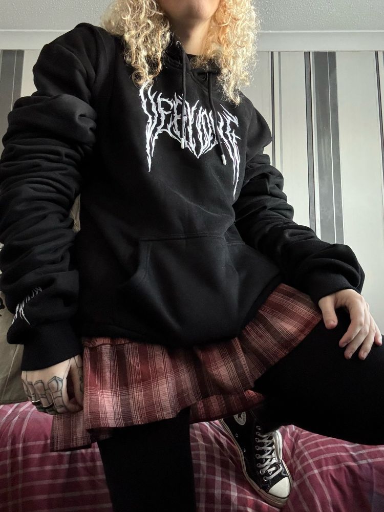 A picture of me in a black hoodie, leggings, converse and a skirt