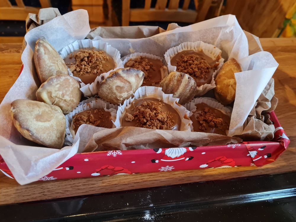 photo of a giftbox with homemade baked goods, including madeleine cakes and mini cheesecakes