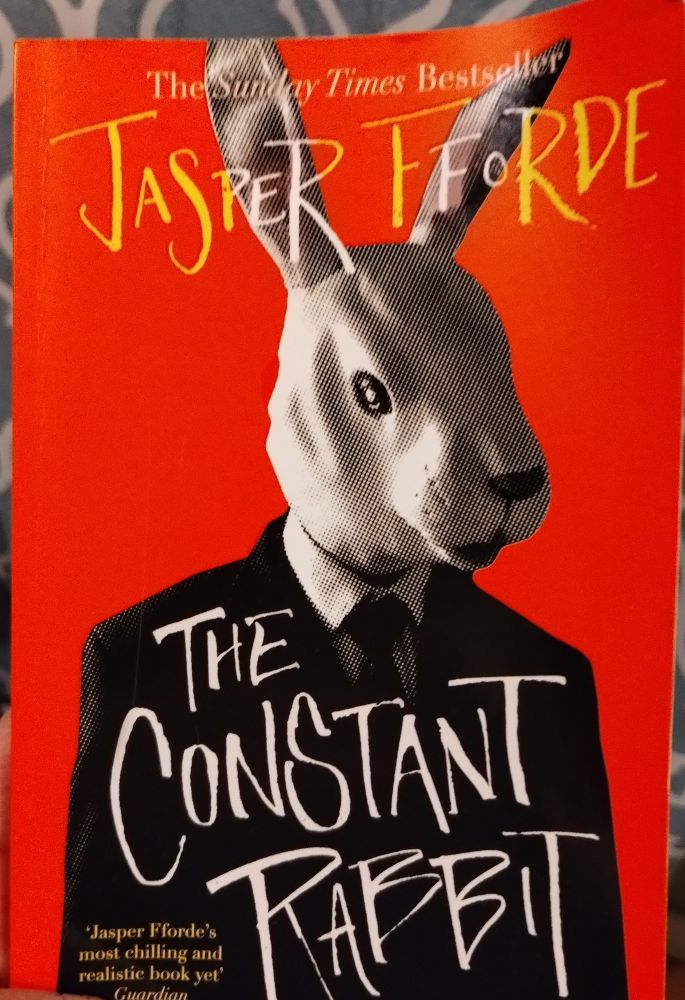 The cover of Jasper Fforde's book The Constant Rabbit, featuring a rabbit wearing a suit and tie
