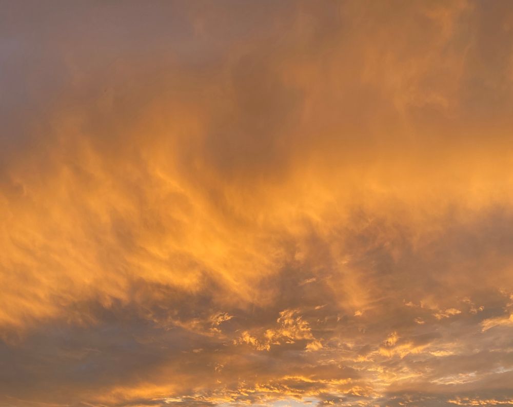 Shot minutes after the other picture: the flame-like clouds are now nearly over me with more lumpy gray but also lit up in orange clouds after while the cool blue sky is now visible in the end