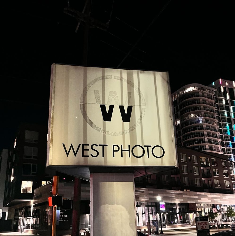 The sign for West Photo in Minneapolis at night.