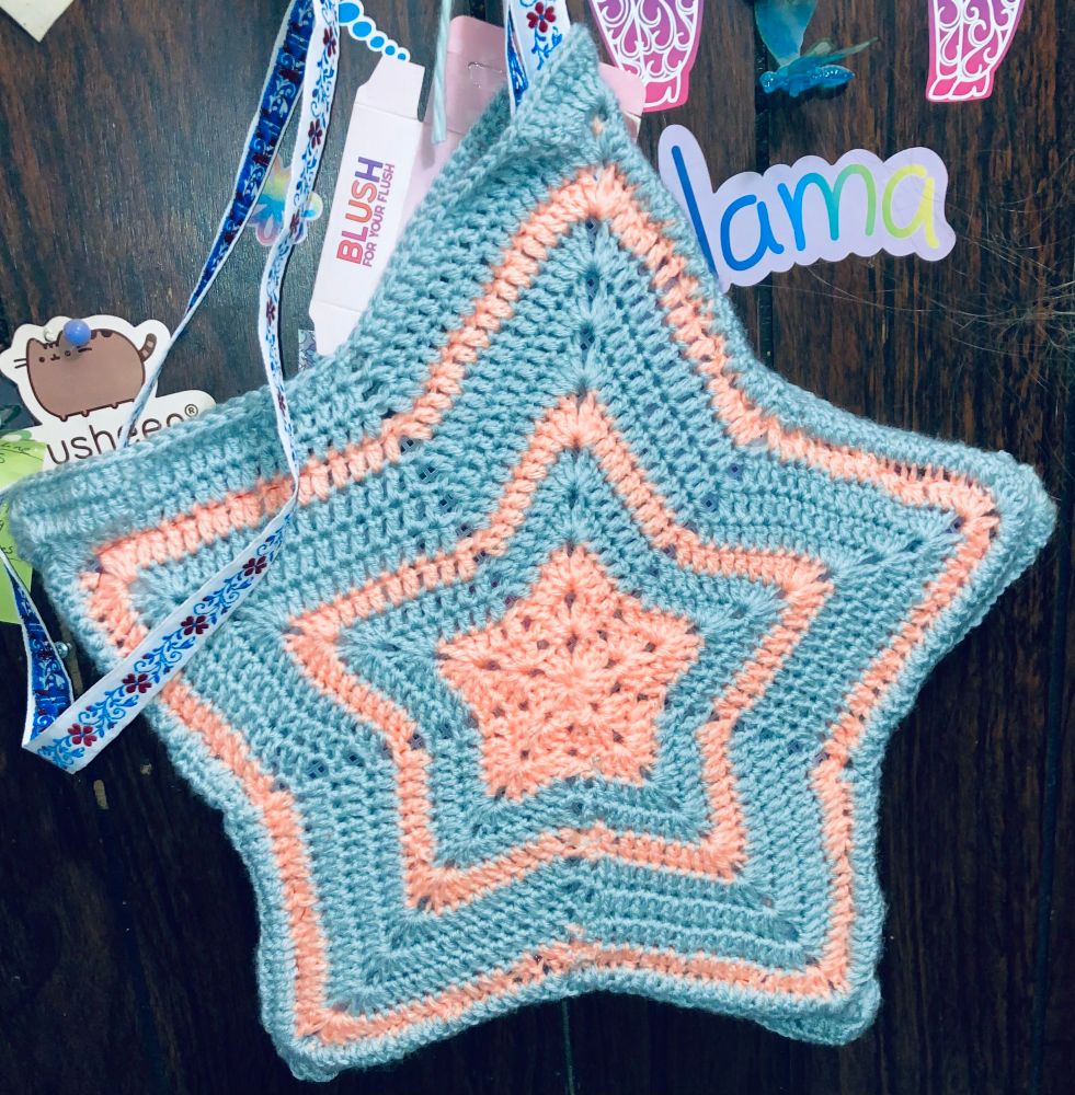 Light blue and peachy orange crochet purse in the shape of a star