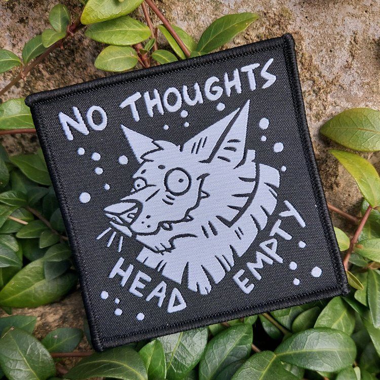A photo of a patch featuring a wolf with a blank stare on its face. Around it are the words No Thoughts Head Empty