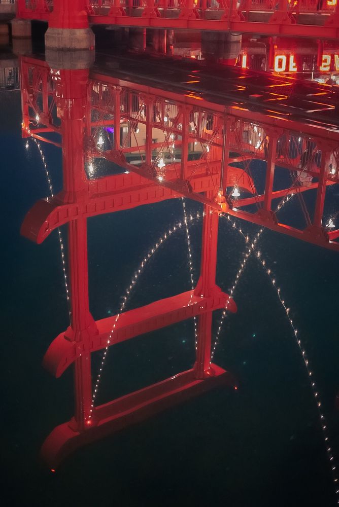 A photo of a reflection on the water of the San Fransokyo bridge at Disney. 
