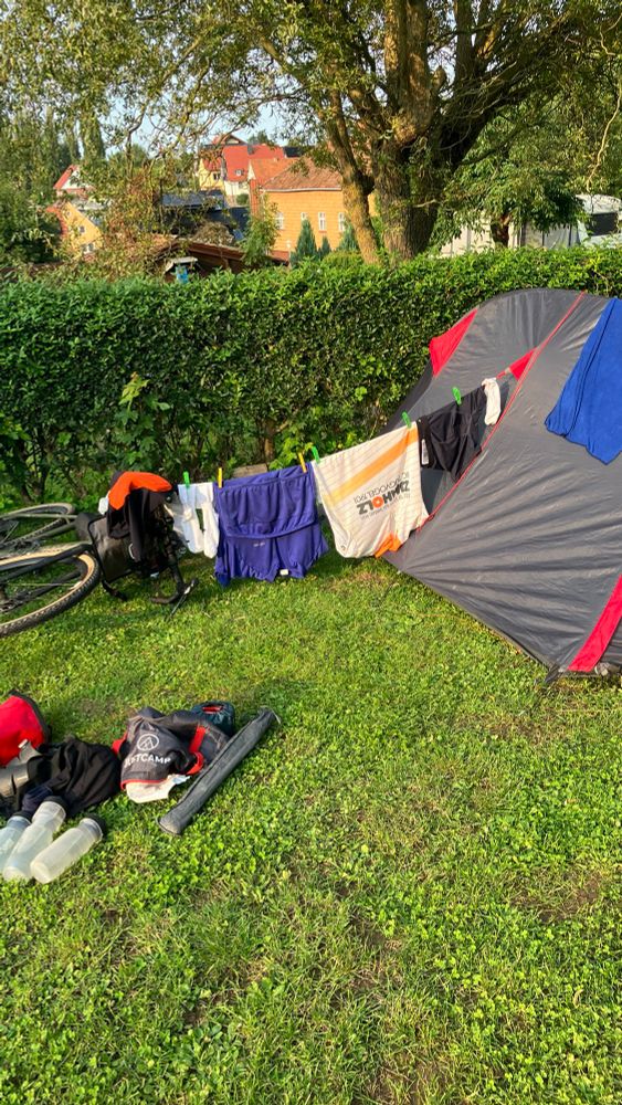 Photo of a clothesline between a tent and a bike