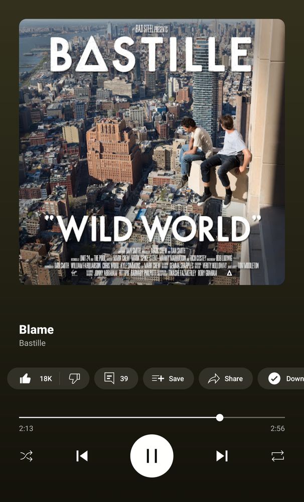 Music app interface- the featured song is "Blame" by Bastille, from the album Wild World. Album cover features a vast cityscape with 2 figures sitting on a ledge overlooking the city.