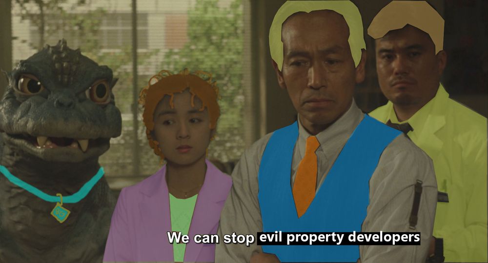 A frame from Godzilla vs Mechagodzilla II (1993) but some horrible MS Paint-quality alterations have been made to make the three human characters look like Daphne, Fred, and Norville "Shaggy" Rogers from Scooby Doo. Baby Godzilla has a Scooby-esque collar around its neck. Miki would obviously be Velma but she's not in this scene.
And listen, did I get any of the colors right? No, of course not. 
The caption has been changed to read We can stop evil property developers.