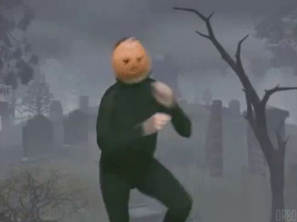 a person with a pumpkin on their head dancing in a cemetery