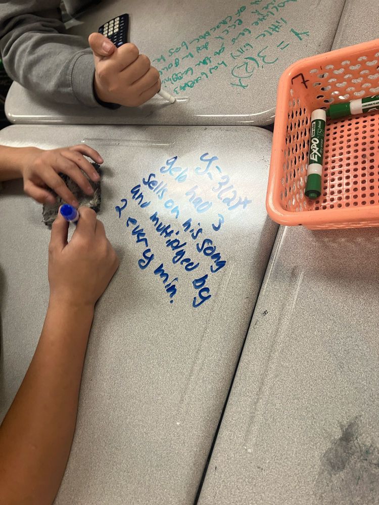 Students writing situations based on exponential equations