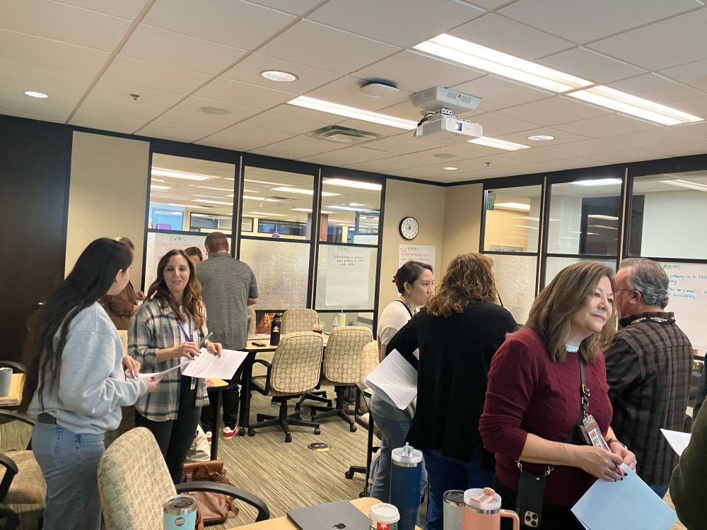 Teachers and administrators, talking in pairs
