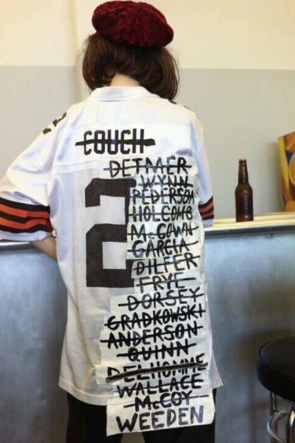 poor Browns fan with a jersey listing about 15 bad quarterbacks they've had