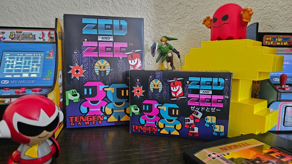 Zed and Zee NES and Famicom boxes on display with other retro video game collectibles.