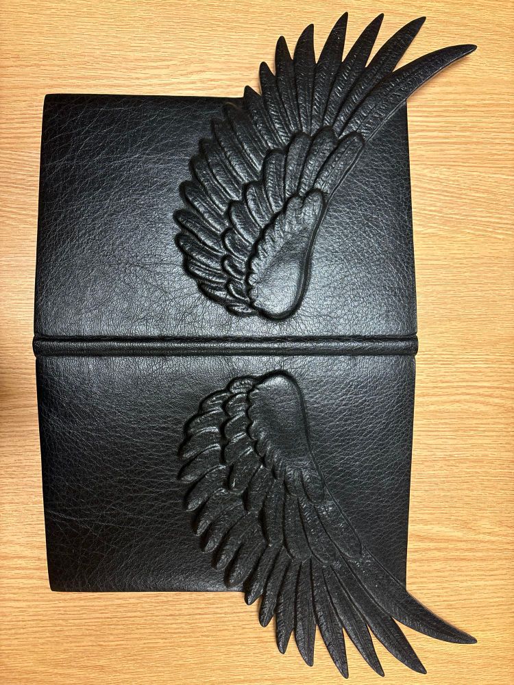 The book’s binding spread to make the two wings visible. The book was very comfortable with being opened this way :)