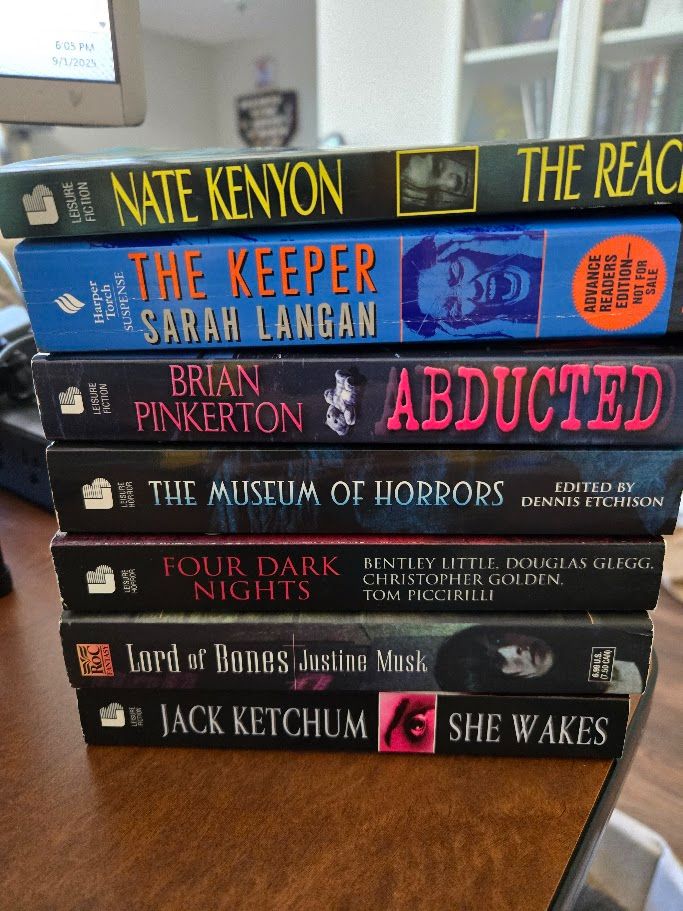 A pile of paperbakc books byt a lot of authors I'm not going to list in the alt text.