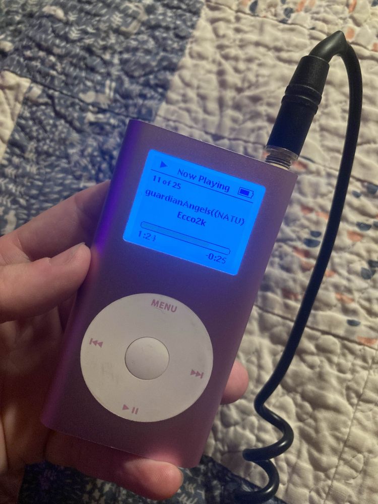 photo of a hand holding a pink iPod Mini, playing guardianAngels by Ecco2k
