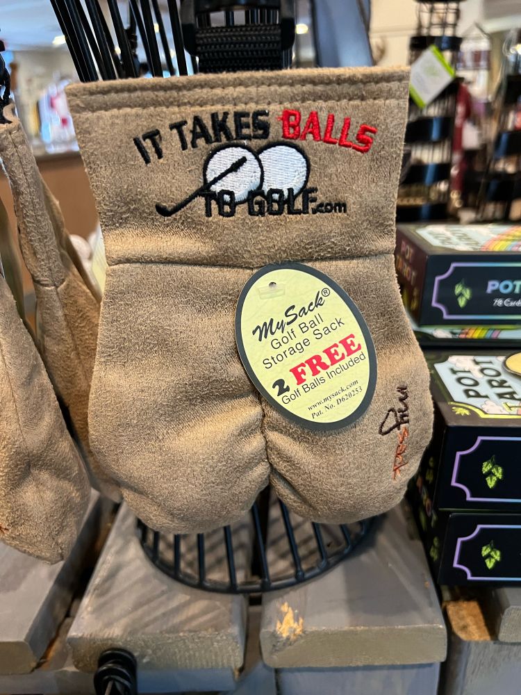 A pouch for carrying golf balls called MySack that is shaped like a scrotum and has the text It Takes Balls to Golf on it