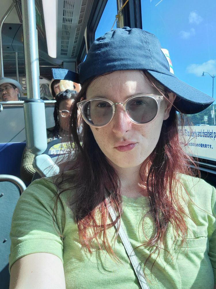 Pouty chicago hat girl on bus in honolulu