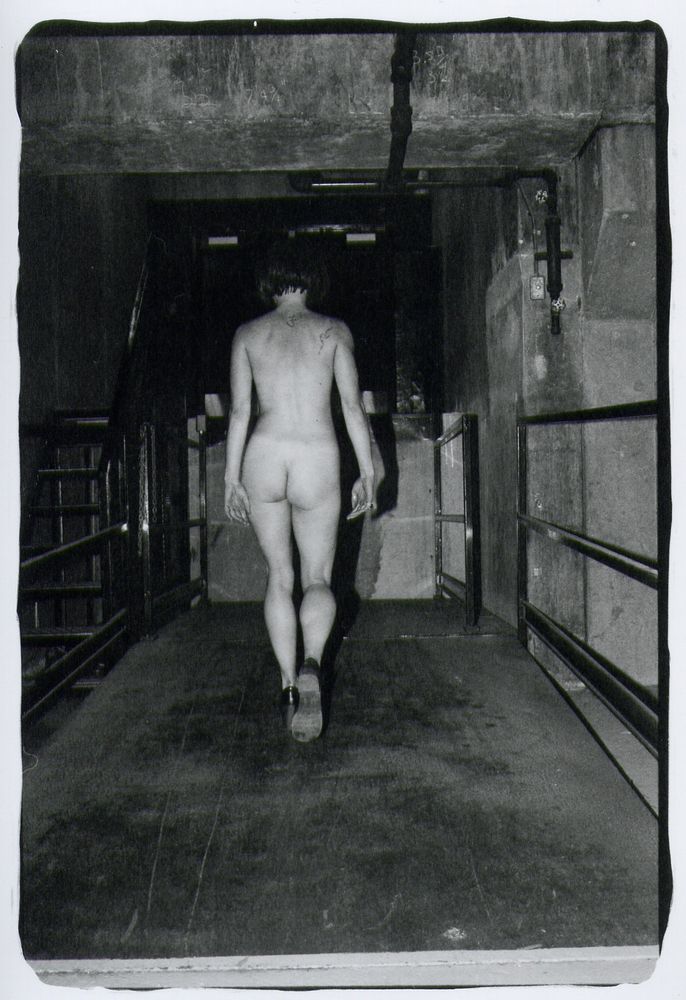 sparklefaerie walking naked on a loading dock, rear view