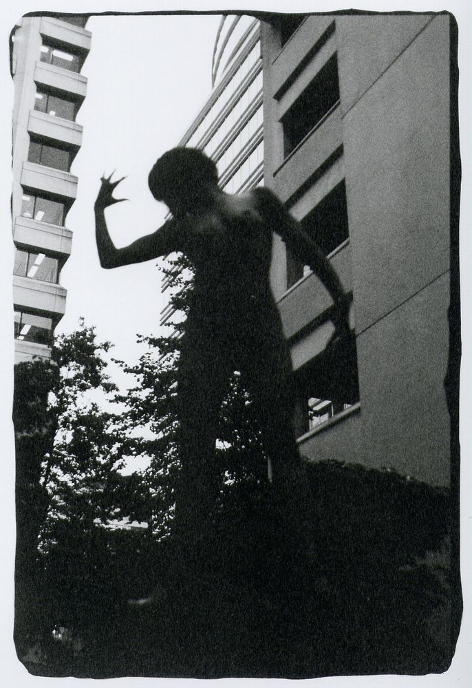 soarklefaeire on Mellevile st., downtown Cancouver as a statue naked in twighlight