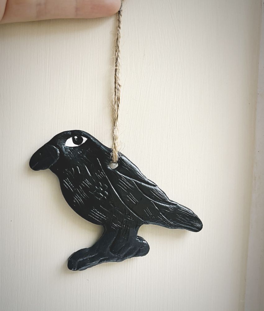 A handmade raven clay decoration.