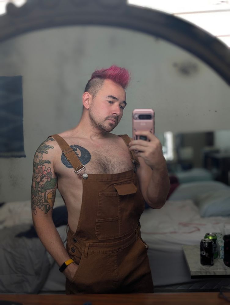 a portrait photo of me wearing some slutty overalls and nothing else
