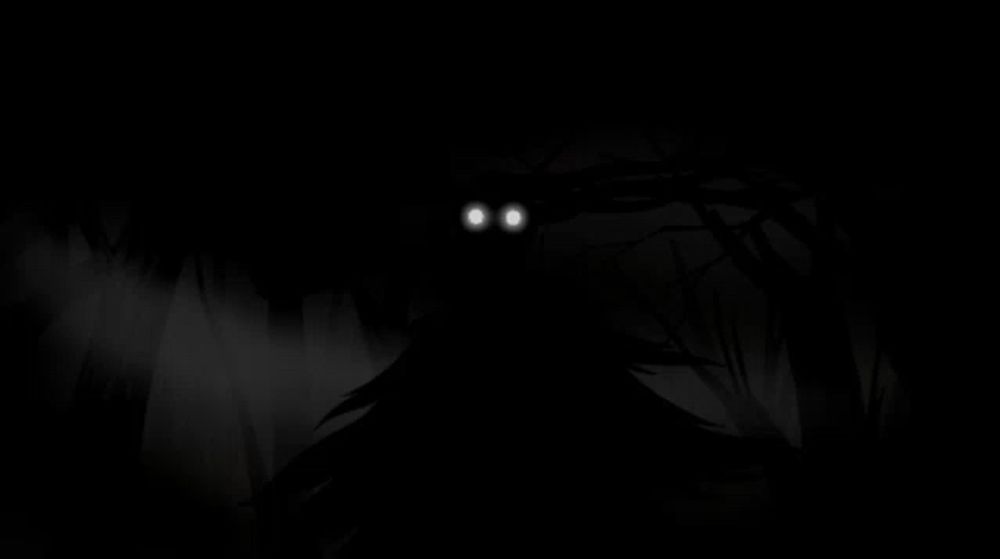 a monster with glowing eyes is coming out of the woods in the dark .