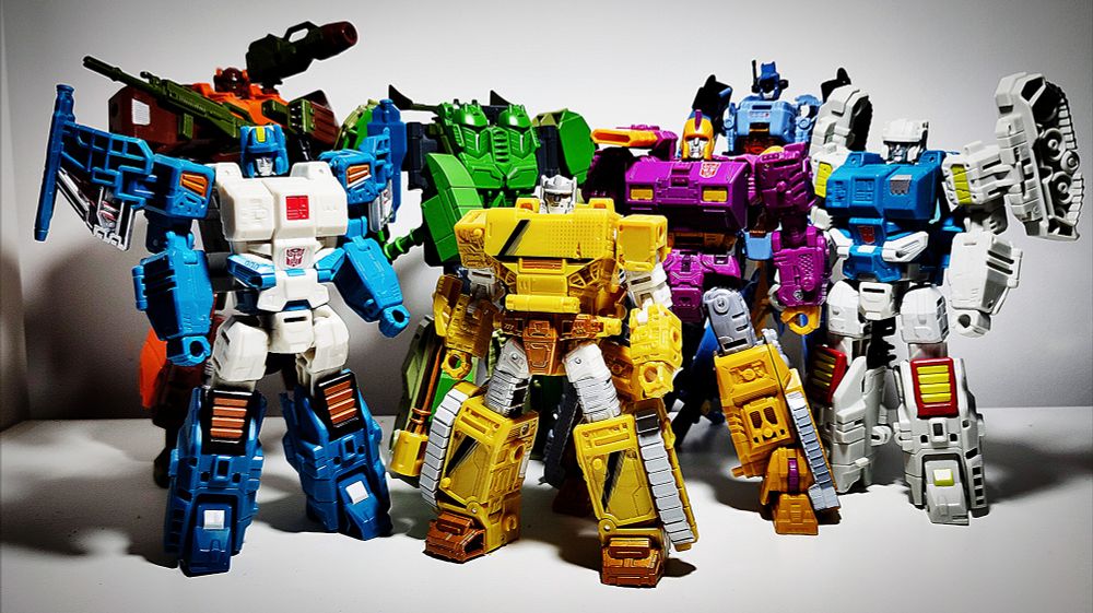 On a school trip to Marvel in London in the 80's, this guy asked me if I liked Autobots or Deceptions better, he wasn't much older then me I reckon, some intern or something. 

I said "Autobots, but I just wished they were grittier and more hard-edged, y'know? Like they needed some sort of commando unit who could get the dirty deeds done when others couldn't."

The guy mulls it over, says "Hmm. What would these guys motto be?", and I said, "I reckon... Reckon.... Rule something, I dunno. You'd have to ask my friend, he's an ideas guy, real impactful."

I pointed to him. "That's him, that's Aaron. He knows his stuff, he's golden. Give him a whirl."

The guy I was talking too?

Nick Roche