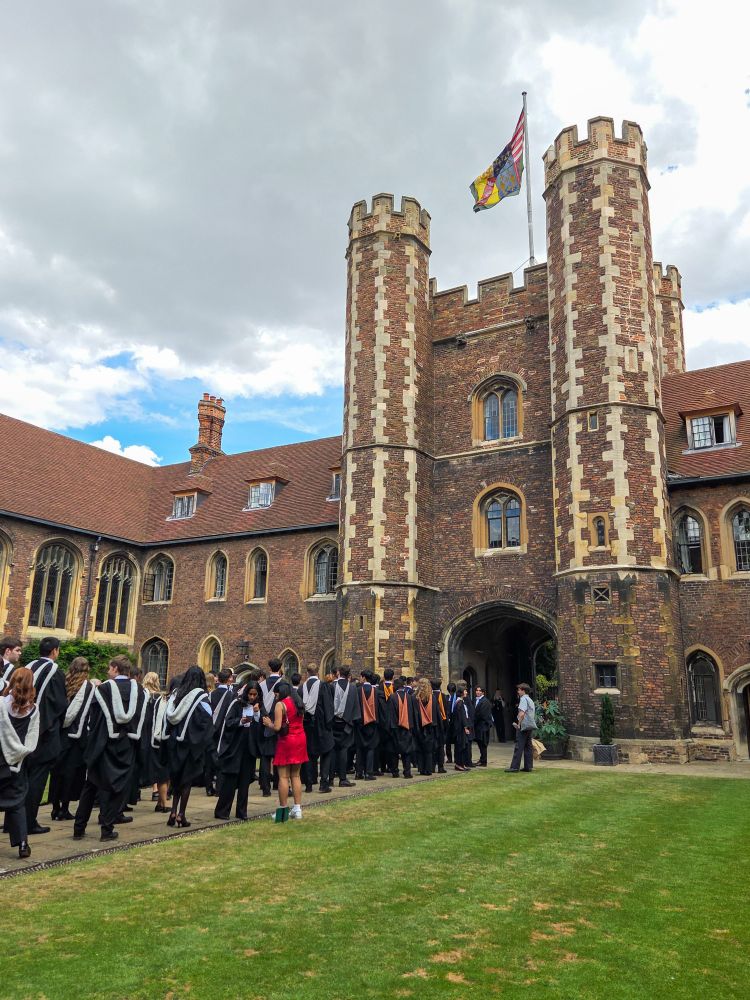 Students lined up in their gowns ready to leave Queens' College to go to their graduation ceremony