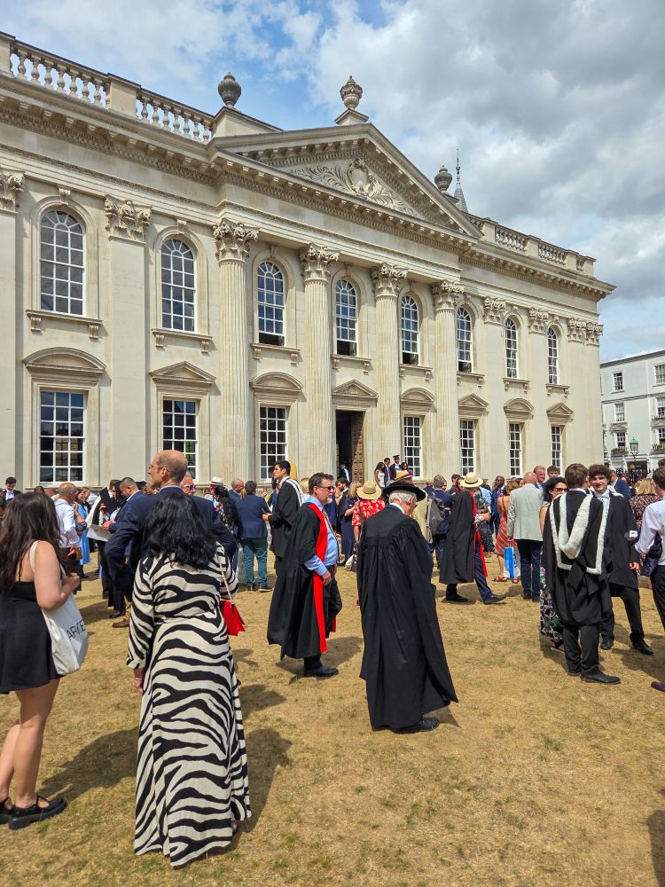 Students and family gathered outside the Senate House in Cambridge after their ceremony